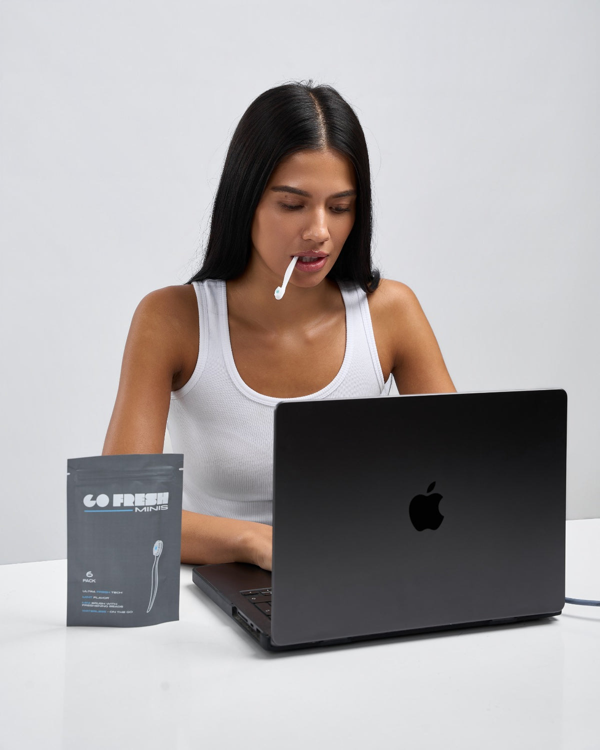 Woman at her desk with a Go Fresh Minis 6-pack