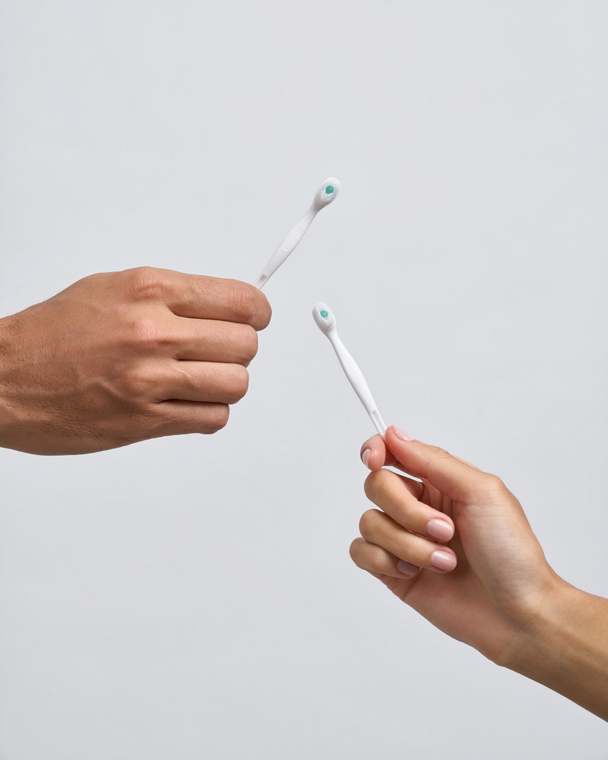 Go Fresh Minis disposable mini toothbrushes held in hand