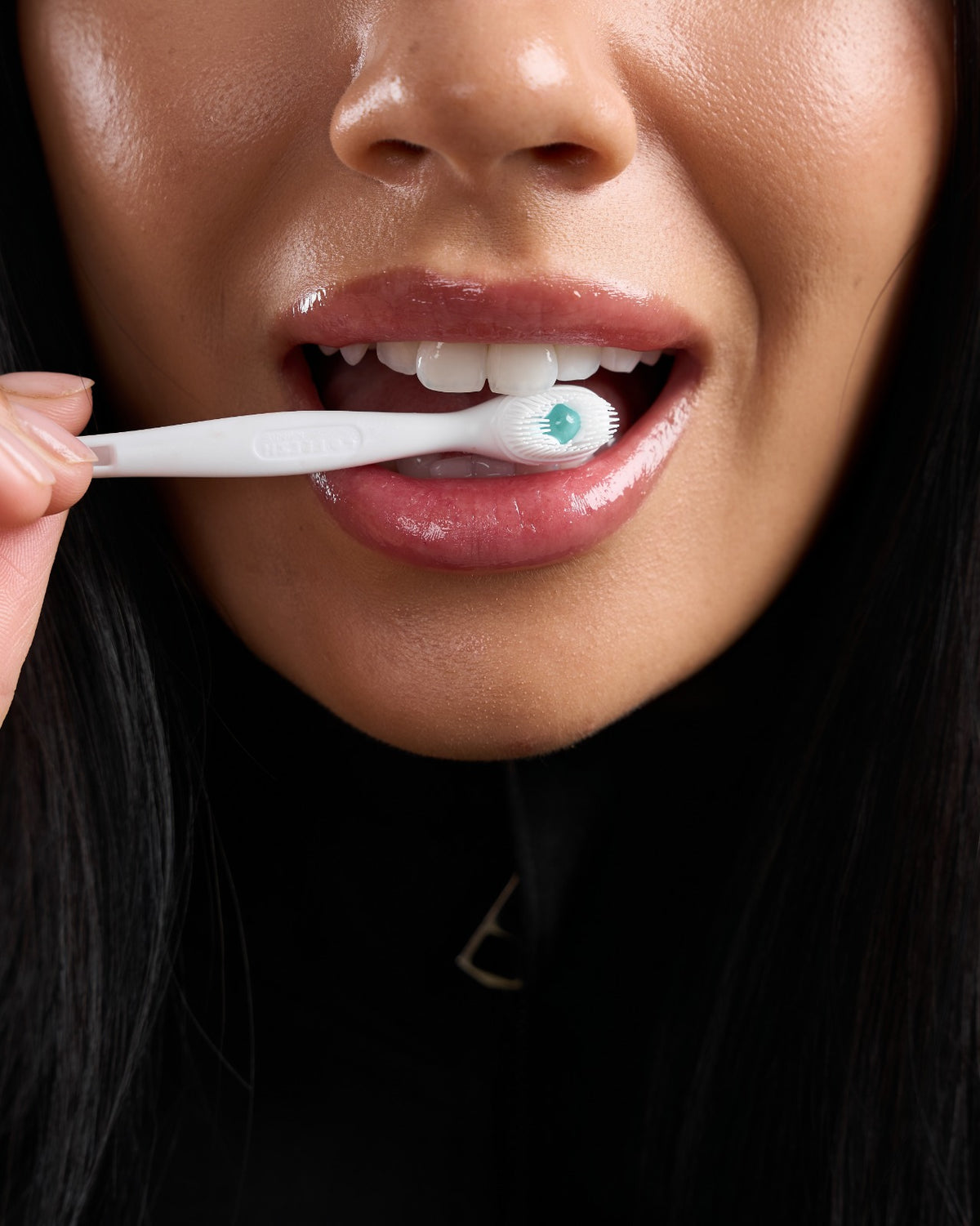 Close-up of a Go Fresh Mini toothbrush in use
