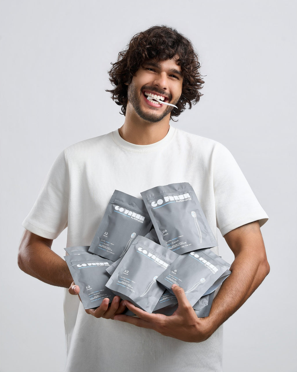 Man holding an armful of Go Fresh Minis packs